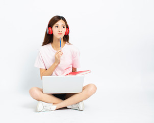 Happy student girl sitting on the floor using laptop