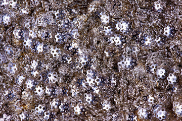 Background texture of silver beads close-up.