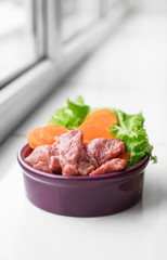 Bowl with fresh pet food on window sill
