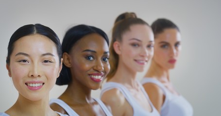 Portrait of women of different ethnicities with beautiful faces and perfect skin just cleaned from impurities ready for day or night cream are smiling in camera.