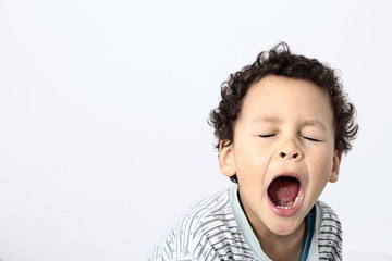 little boy yawning with textured background stock photo