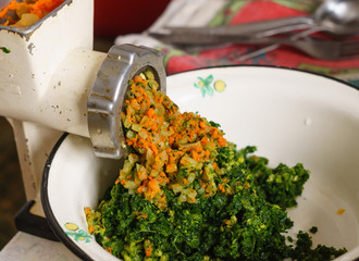 Chopping vegetables in an old meat grinder