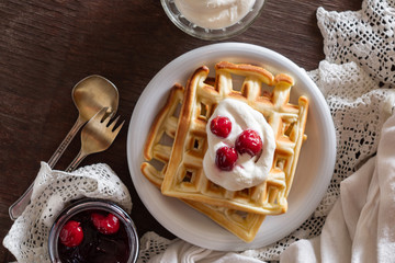 Waffles with sour cream and cherry jam