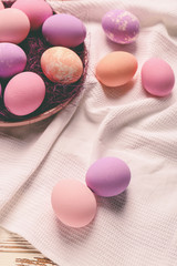 Plate with Easter eggs on table