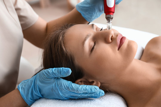 Young woman undergoing procedure of bb glow treatment in beauty salon