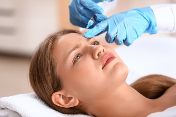 Fototapeta na wymiar Young woman receiving injection in beauty salon