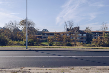green zone of autumn tress in front of residential area