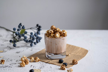 Cocoa with chocolate popcorn on a white table.