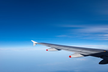 Fototapeta na wymiar Airplane Wing - Flying above the Clouds