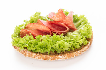 Sandwich with salami sausage on white background.