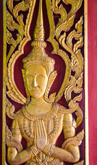 wooden fairy statue on door of church