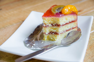 piece of stawberry cake was eating on white plate