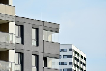 Multistory new modern apartment building. Stylish living block of flats.