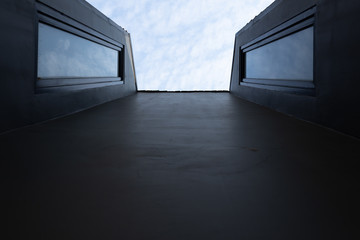 ant's eye view of building with cloud reflection in window.