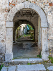 Fototapeta na wymiar Ancient Archway into a Courtyard in Southern Italy