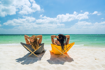 Two Women enjoying their holidays on the tropical beach