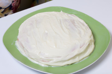 Cooking the pie with mascarpone cream. Ready cake, greased by impregnation.