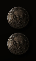 old coin on black background