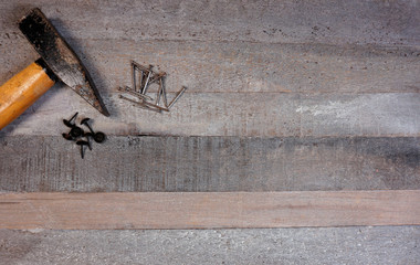 Hammer and nails on natural wooden background with copy space for your own text