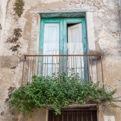 Door and Balcony in an Old Building in Southern Italy
