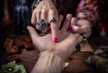 Gypsy fortune teller predicts the future by chiromancy