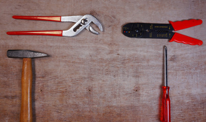 Set Hand Tools with Hammer, pincers, screwdriver, on wooden background