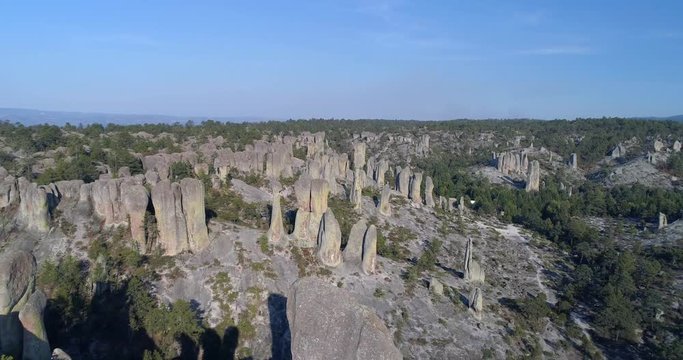 Aerial dolly back shot over rock formations in El Valle de loss Monies, Copper Canyon Region, Chihuahua.