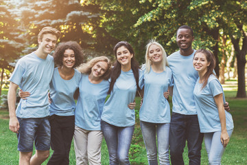 Group of young volunteers embracing at park