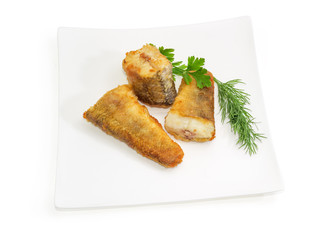 Slices of the fried fish and greens on square dish