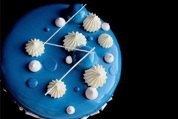 Blue and white cake with white chocolate and mirror glaze on black background