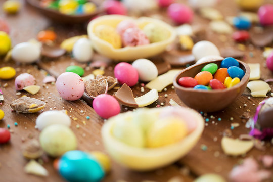 chocolate easter eggs and candy drops on table