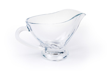 Empty glass gravy boat on a white background