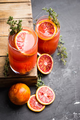 Bloody oranges beverage with thyme. Selective focus. Shallow depth of field.