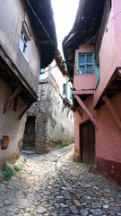Obraz premium Historic Narrow Street with Ottoman Houses in a Turkish Village Cumalikizik Bursa Turkey 