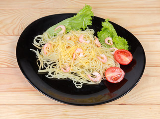 Cooked Spaghetti pasta with shrimps, cheese, cherry tomatoes and lettuce