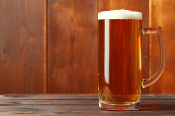 Glass beer on wood background