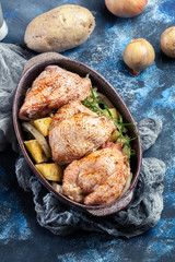 Chicken thighs and potatoes ready for baking