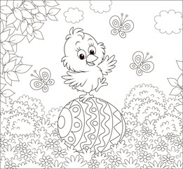 Little Easter Chick dancing on a big decorated egg on a lawn on a sunny spring day, black and white vector illustration in a cartoon style for a coloring book