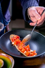 Chef decorates the salad with beef, eggplant and goat cheese. Master class in the kitchen. The process of cooking. Step by step. Tutorial. Close-up