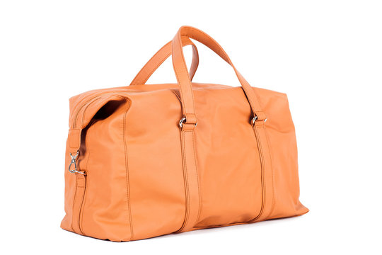 Orange-brown  leather bag for storing things and traveling on a white isolated background. Luggage, handmade suitcase
