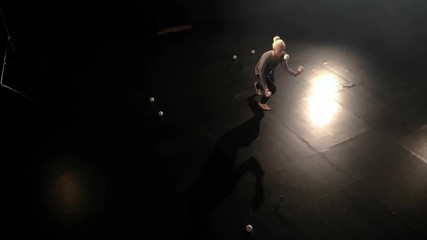 Aerial shot - Circus juggler makes amazing tricks with balls.