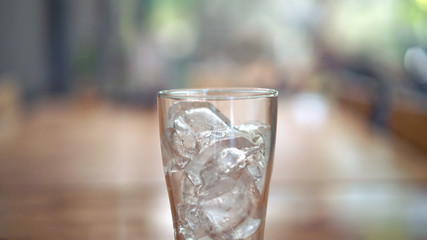 Glass of ice on the wooden table
