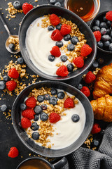 Yogurt with berries and granola in bowl