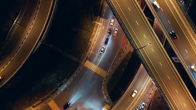Aerial photography. The camera rises perpendicular to the road. Night road to Sochi. The lights of the highway. Transport interchange. night time.