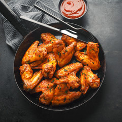 Chicken wings grilled in sauce on pan