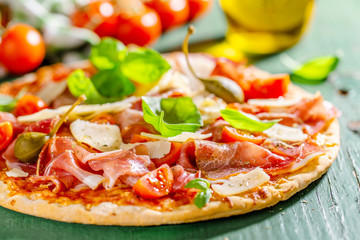 Appetizing italian pizza with prosciutto