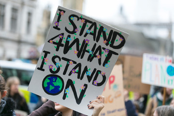 People with banners protest as part of a climate change march