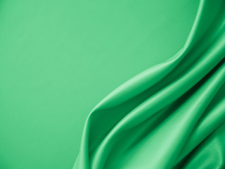Beautiful smooth elegant wavy light green satin silk luxury cloth fabric texture, abstract background design. Card or banner.