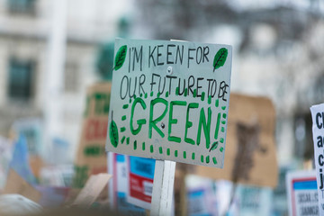 People with banners protest as part of a climate change march