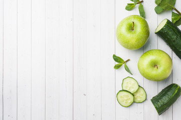 Green cucumber mint Apple on the table. The concept of diet and vegetarianism. Copy space.